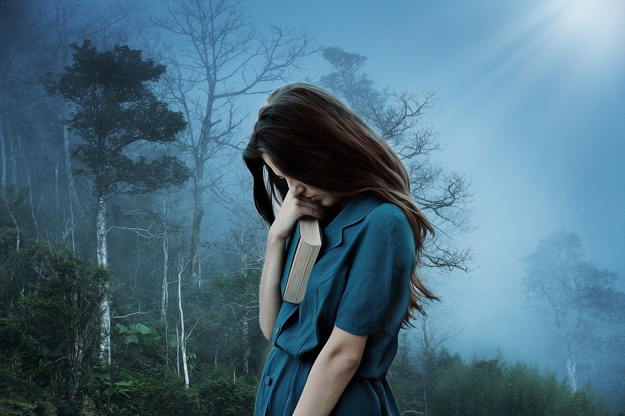 Depressive Frau in dunklem Wald